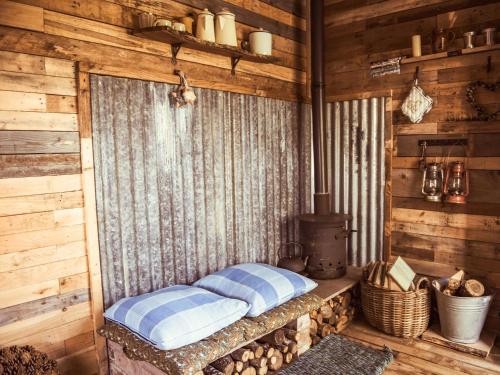 a room with a bed in a log cabin at The Mamgu Lodge in Mochdre