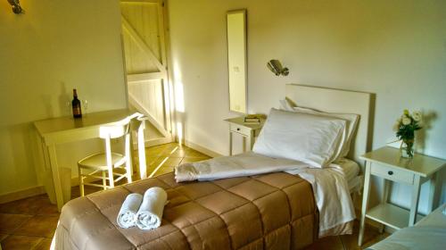 a bedroom with a bed with two slippers on it at Casale Laurus in Locogrande