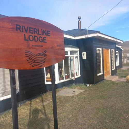 a sign in front of a tiny house at Riverline lodge in Cerro Castillo