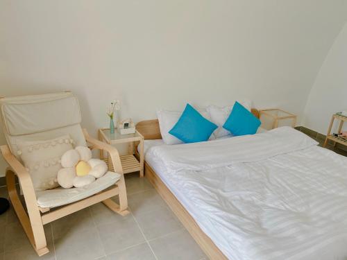 a bedroom with a bed and a chair at Malis Homestay in Trà Vinh