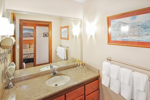 a bathroom with a sink and a mirror at Partial Oceanview 1BR at Kiahuna Plantation Unit 311 in Koloa