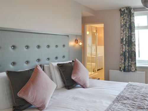 a bedroom with a large white bed with pillows at Crows Nest in Bridlington