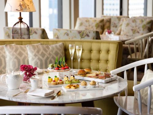 a table with plates of food on it at Pan Pacific Singapore in Singapore