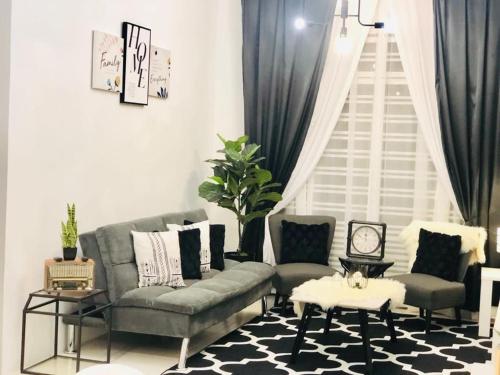a living room with a couch and two chairs at Villa Pool Kepala Batas in Kampong Hilir