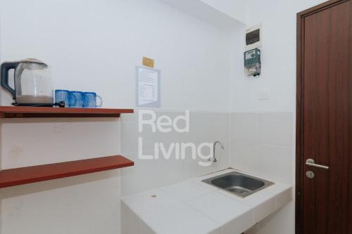 a kitchen with a sink and a counter at RedLiving Apartemen Gunung Putri Square - TOP Room in Parungtandjung