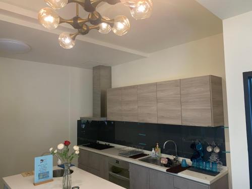 a kitchen with a sink and a chandelier at Guan Shan Pavilion in Guanshan
