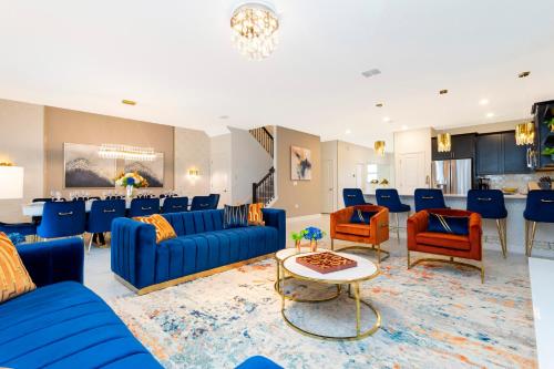 a living room with blue couches and a table at 9312 SH - Champions Gate - Unique High end 8 Beds in Davenport