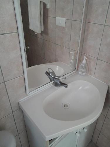a bathroom with a white sink and a mirror at Cabanas bahia inglesa in Bahia Inglesa