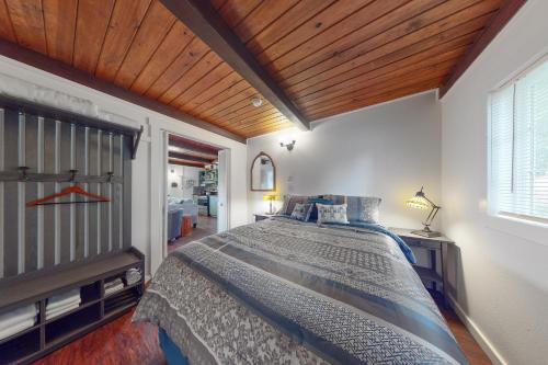 a bedroom with a large bed with a wooden ceiling at Bay Bliss #2 in Reedsport