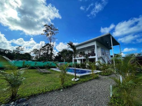 a house with a swimming pool in front of it at Oso Perezoso Pool Villa in Puerto Viejo