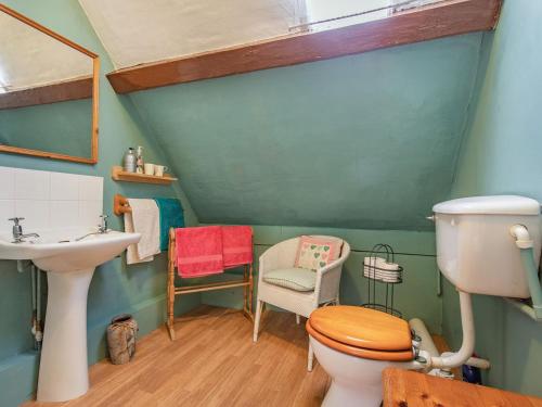 a bathroom with a toilet and a sink at The Saddlery in Shirley