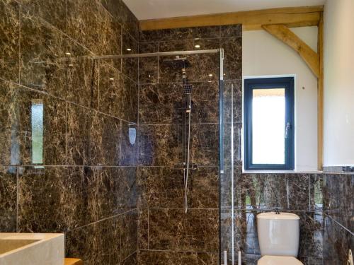 a bathroom with a glass shower with a toilet at Oak View in Highgate