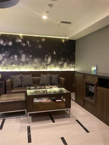 a living room with a couch and a table at Hotel Regent (Adult Only) in Nagoya