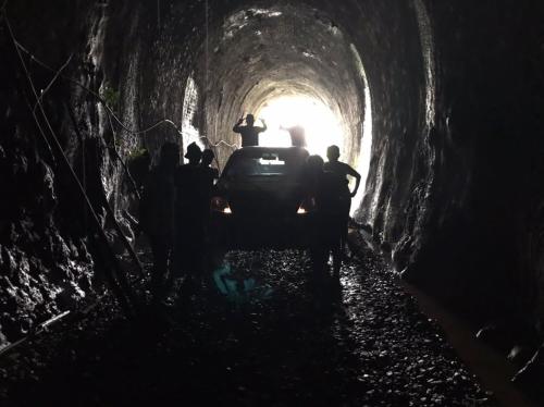 a group of people standing in a dark tunnel at MyDusun Chalet, Taiping, Perak, Malaysia in Taiping