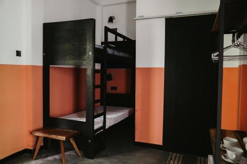 a room with two bunk beds and a chair at Jungle Soul in Mirissa