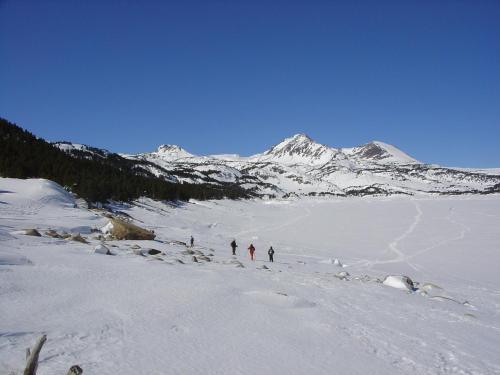 a group of people skiing on a snow covered mountain at Hotel et Résidence Le Clos Cerdan in Mont-Louis