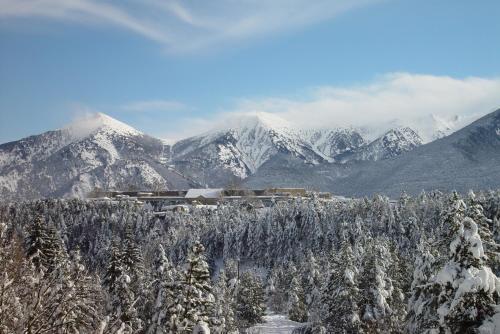 a resort in the mountains with snow covered mountains at Hotel et Résidence Le Clos Cerdan in Mont-Louis