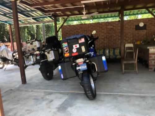 a motorcycle parked inside of a garage at MyDusun Chalet, Taiping, Perak, Malaysia in Taiping