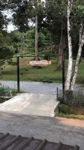 a park with a sign on the side of a road at MyDusun Chalet, Taiping, Perak, Malaysia in Taiping