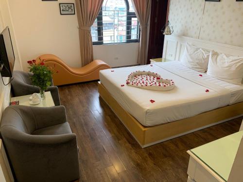 a hotel room with a bed with a cake on it at Khách Sạn A83Hotel in Hanoi