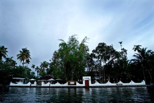 a view of a body of water with palm trees at Bamboo Lagoon Backwater Front Resort in Alleppey