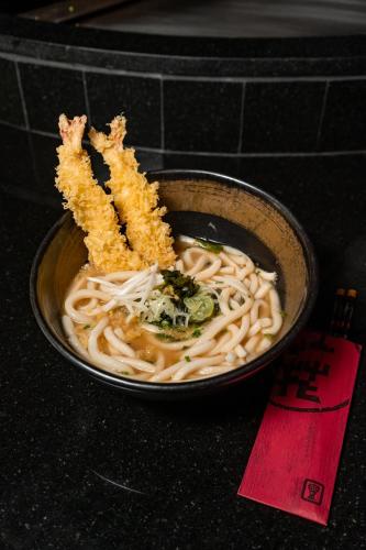 a bowl of noodles with fish sticks on top at JW Marriott Phuket Resort and Spa in Mai Khao Beach