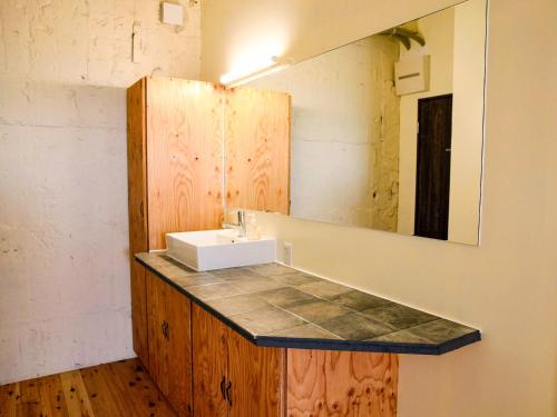 a bathroom with a sink and a mirror at 14 Guesthouse Mt.Fuji in Fuji