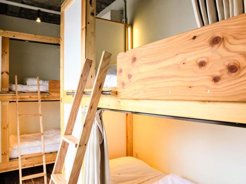 a bunk bed room with a ladder and bunk beds at 14 Guesthouse Mt.Fuji in Fuji