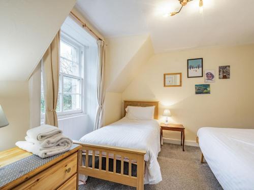 a bedroom with two beds and a window at Black Grouse in Culter