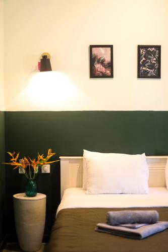 a bedroom with a bed with a green wall at Jungle Soul in Mirissa
