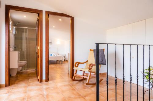 a hallway with a room with a bed and a chair at Finca Sa Pedrera d'es Turó in Manacor