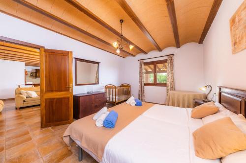 a bedroom with a large bed and a television at Finca Sa Pedrera d'es Turó in Manacor