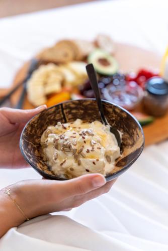 a person holding a bowl of ice cream with a spoon at Serenity Hideaway in Palaiochóra