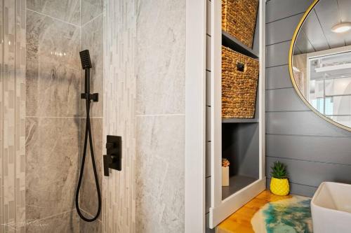 a bathroom with a shower and a sink at Under The Sea Tiny Home in Apple Valley