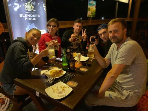 een groep mensen aan een tafel met drankjes bij Sizzle Sports Club in Kandy