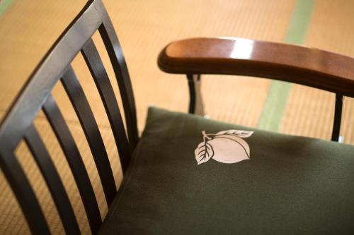a green bag sitting on the back of a chair at Kurobe UnazukiOnsen Togen in Kurobe