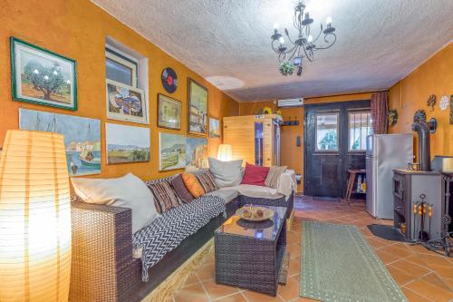 a living room with a couch and a table at Pool House Ančka - Happy Rentals in Marezige