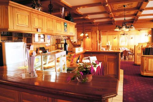 a large kitchen with a counter with flowers on it at Hotel Schloßblick Trebsen in Trebsen