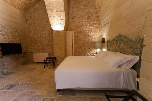 Ένα ή περισσότερα κρεβάτια σε δωμάτιο στο MASSERIA LILEI