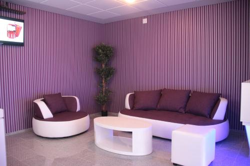 a living room with a couch and a coffee table at Apartmani i Bungalovi TROJKA in Banja Luka