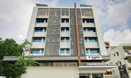 a tall white building with a sign on it at Treebo Tryst Brijinn in Nagpur