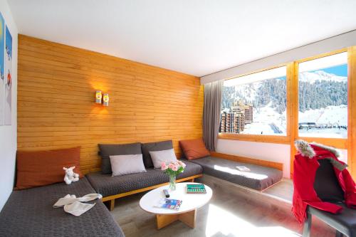 a living room filled with furniture and a couch at Résidence Bellecôte in Plagne Bellecote