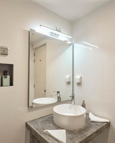 a bathroom with a sink and a mirror at Bliss Dhigurah in Dhigurah