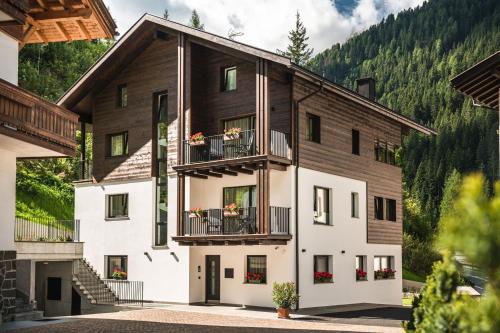 a house in the mountains with two balconies at Chalet Miriam in Selva di Val Gardena