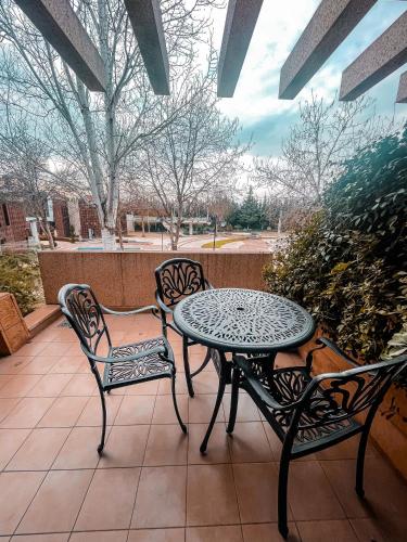 a patio with two chairs and a table and chairs at Layali Al Shams Hotel in ‘Anjar