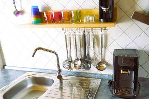 a kitchen sink with a toaster next to a kitchen counter at FEWO Blick Falkenstein in Pfronten