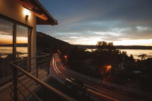 a building with a balcony with a view of a street at Horizont Dedine in Golubac