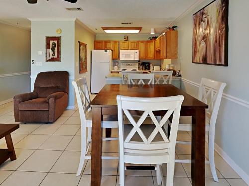 a kitchen and dining room with a table and chairs at Grand Caribbean Perdido Key #114 West in Perdido Key
