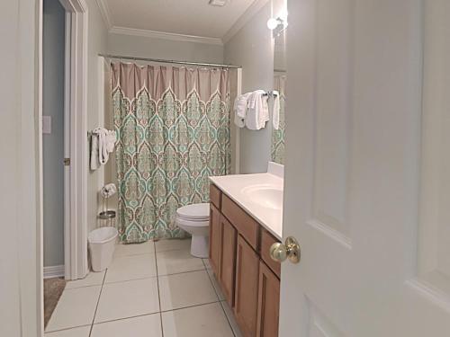 a bathroom with a sink and a toilet and a shower at Grand Caribbean Perdido Key #114 West in Perdido Key