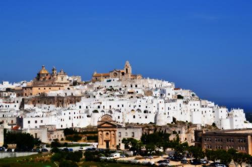 a large white building on top of a mountain at Agriturismo Salinola in Ostuni